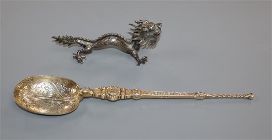 An Edwardian silver gilt replica anointing spoon, by Saunders & Shepherd, Chester, 1907 and a Chinese white metal dragon.